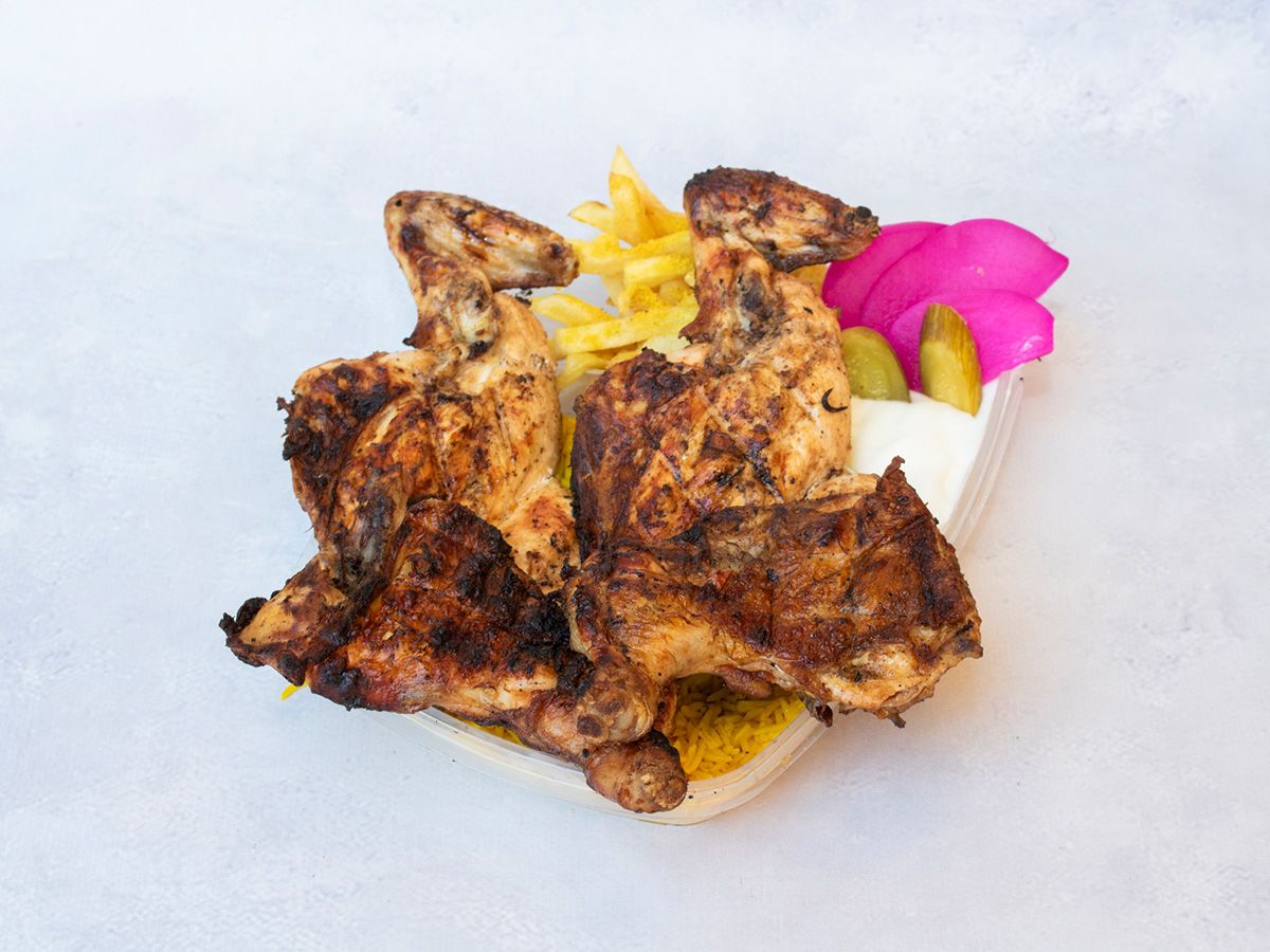 Whole chicken grilled over charcoal