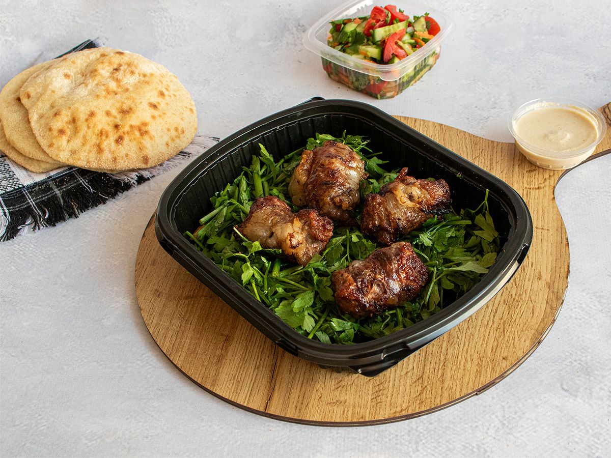 Kilo Of Tarb Lamb Pieces With Green Salad, Bread, And Tahini.