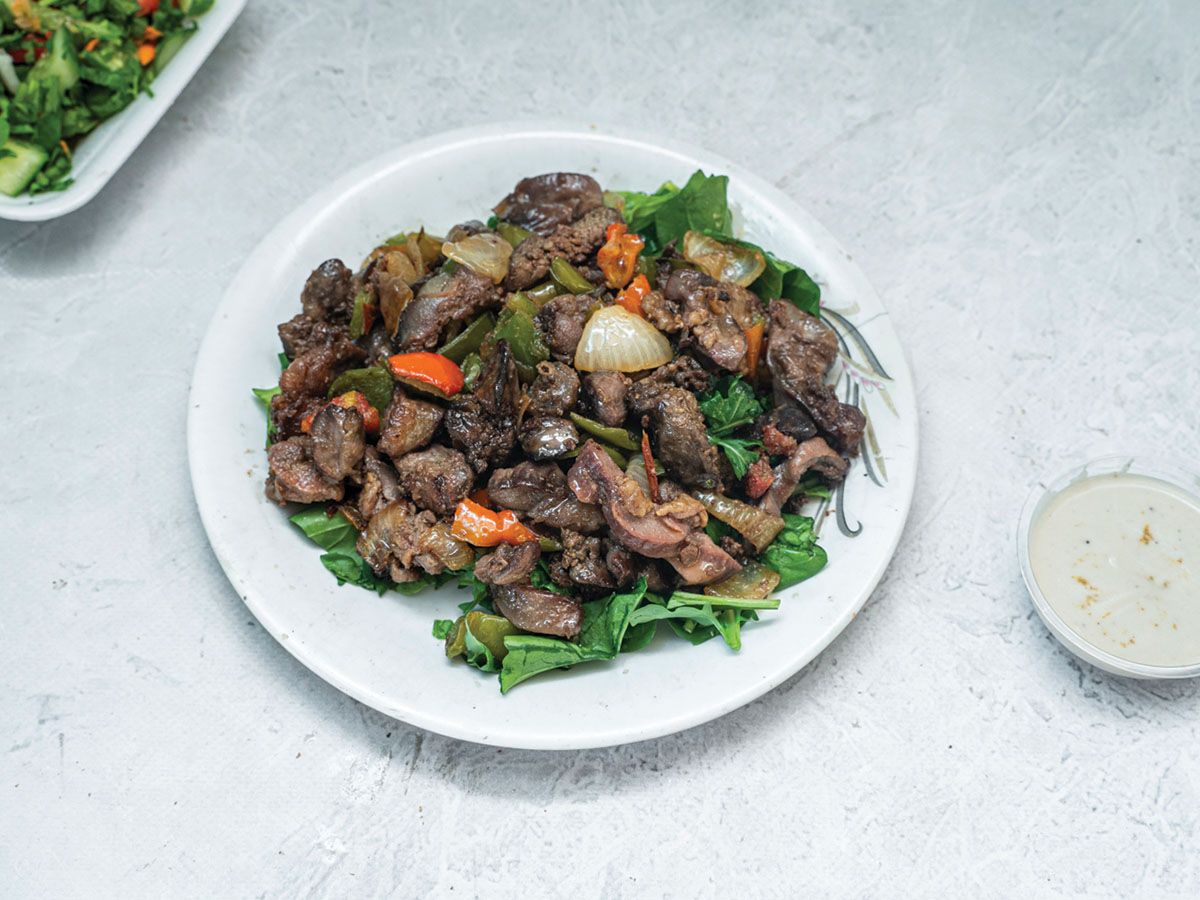Order of liver and Giblets with green salad, bread, and tahini