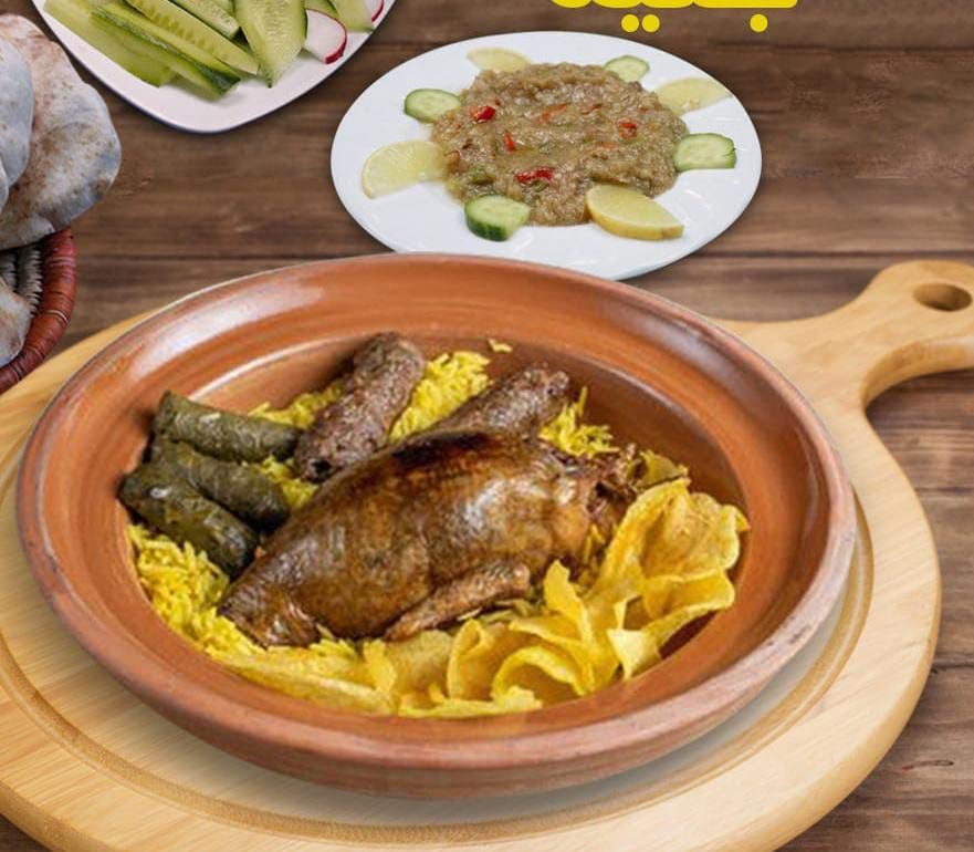 Stuffed pigeon meal with kofta, rice, salad, and bread
