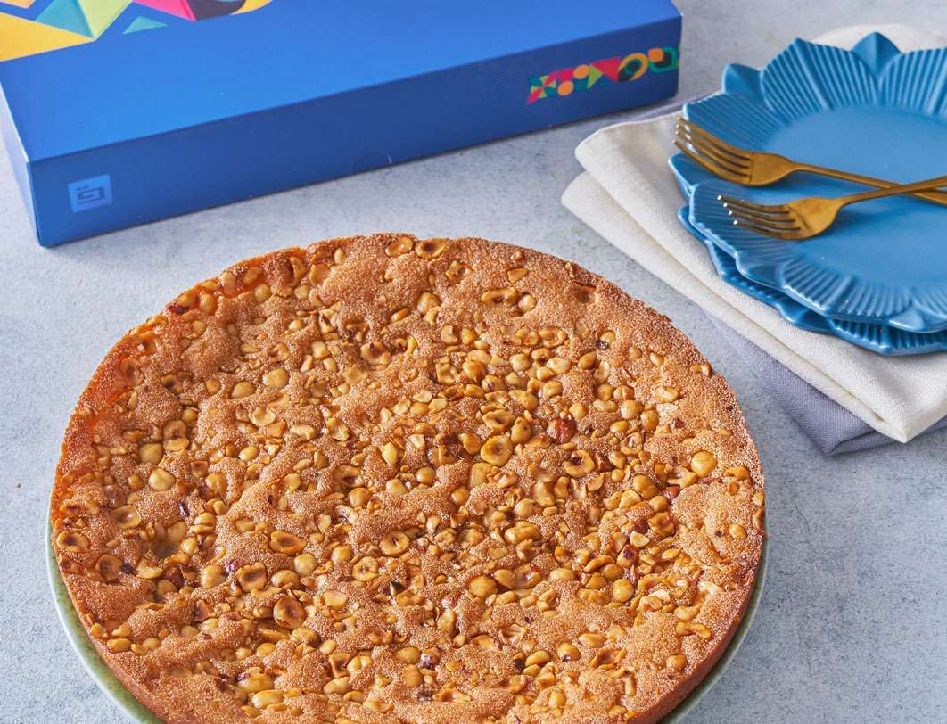 Basbousa tray with hazelnuts.