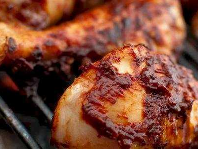 Quarter grilled chicken on charcoal.