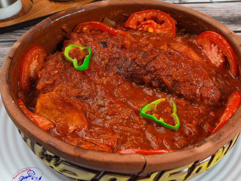 Mullet fish tagine with potatoes and red sauce
