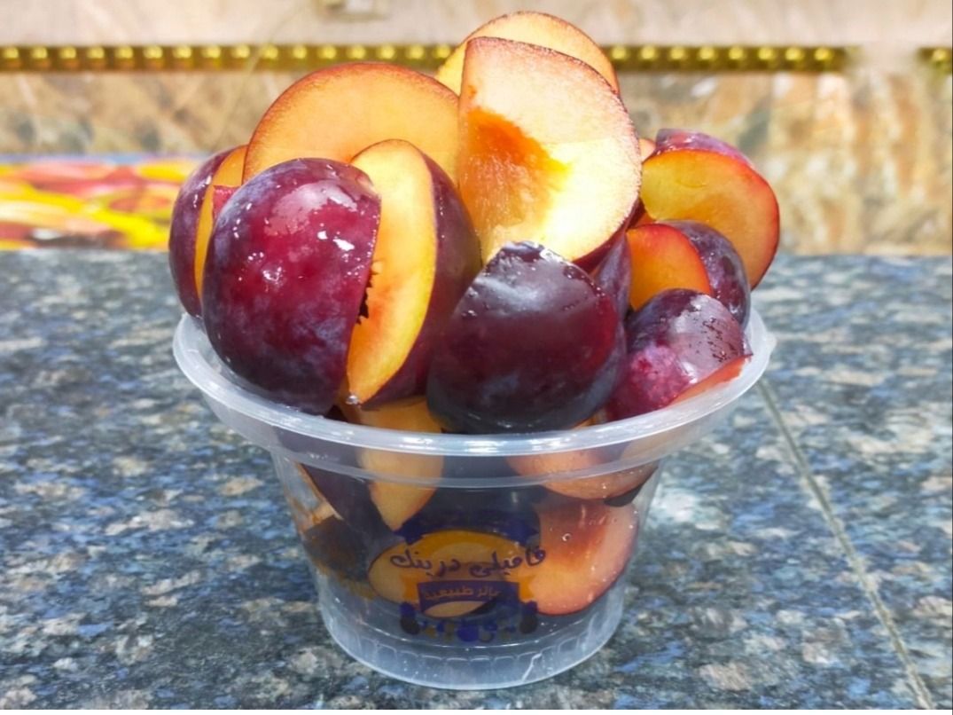 A Box Of Cut Plums