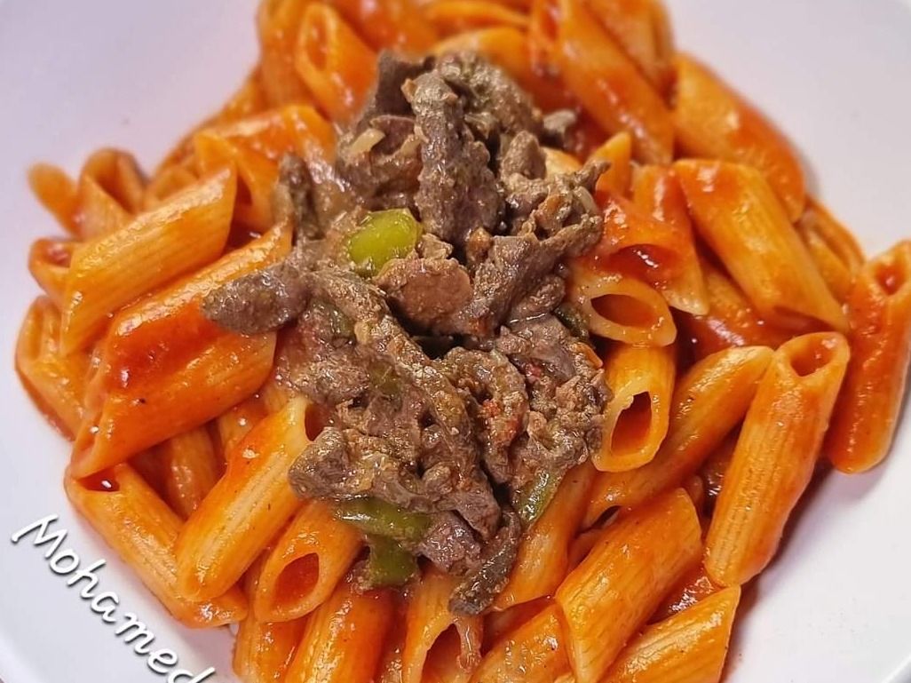 Baked pasta casserole with liver in a clay pot