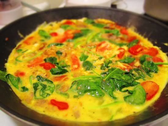 Omelet pan with vegetables, olives, and ghee