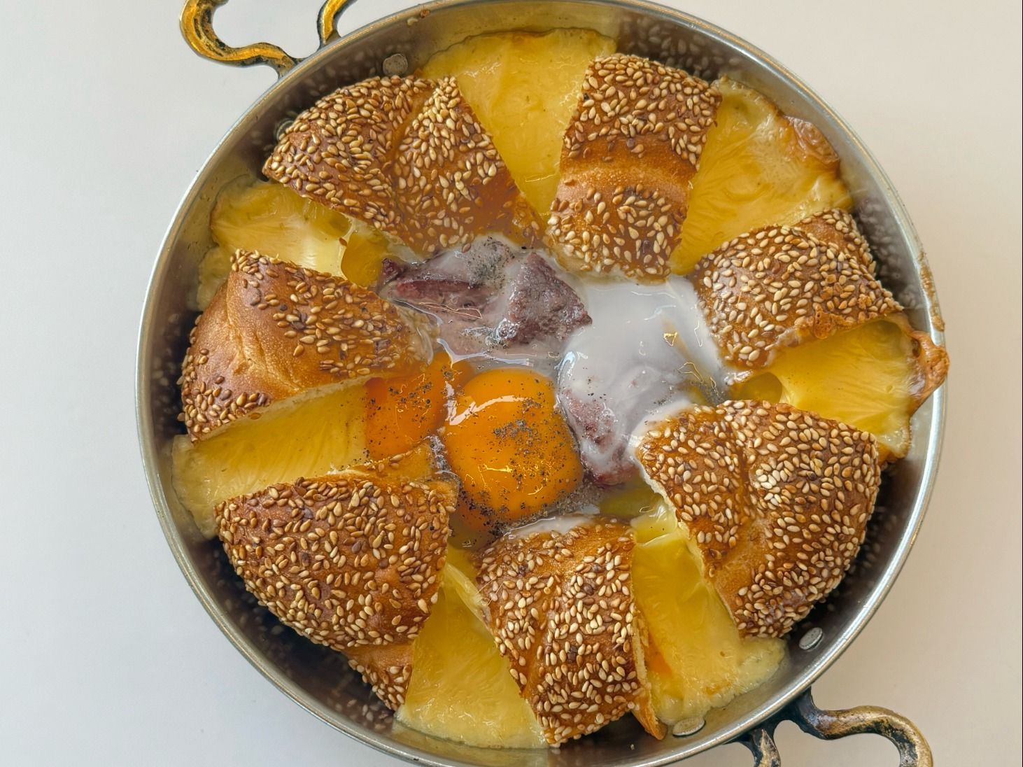 Turkish eggs in a pan with sausage