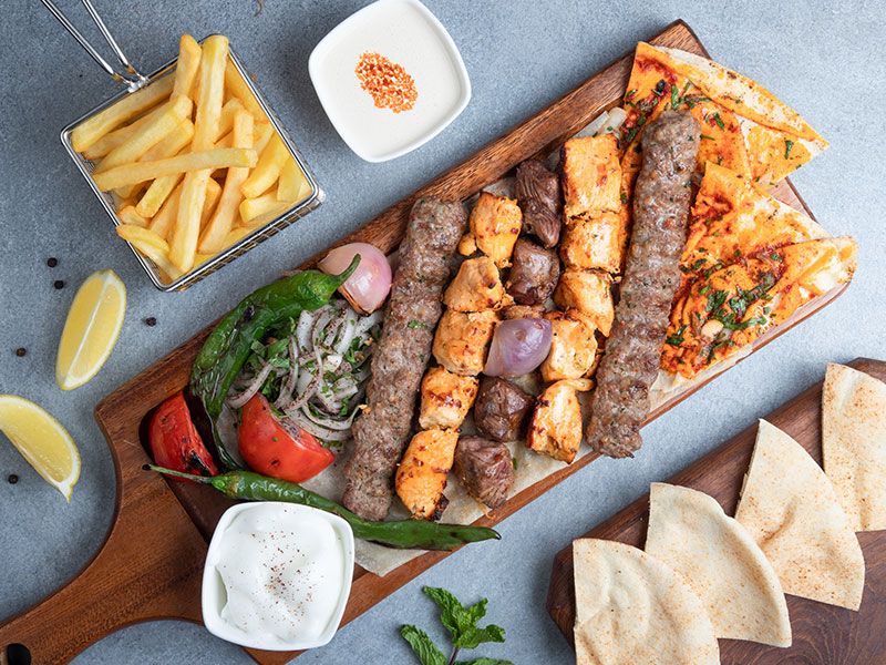 Kilo mixed grill on charcoal with green salad, bread, and tahini